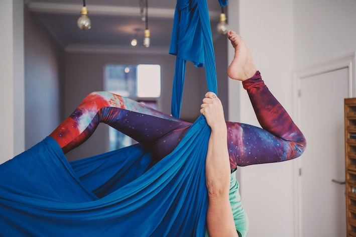 An aerial yoga class using silks