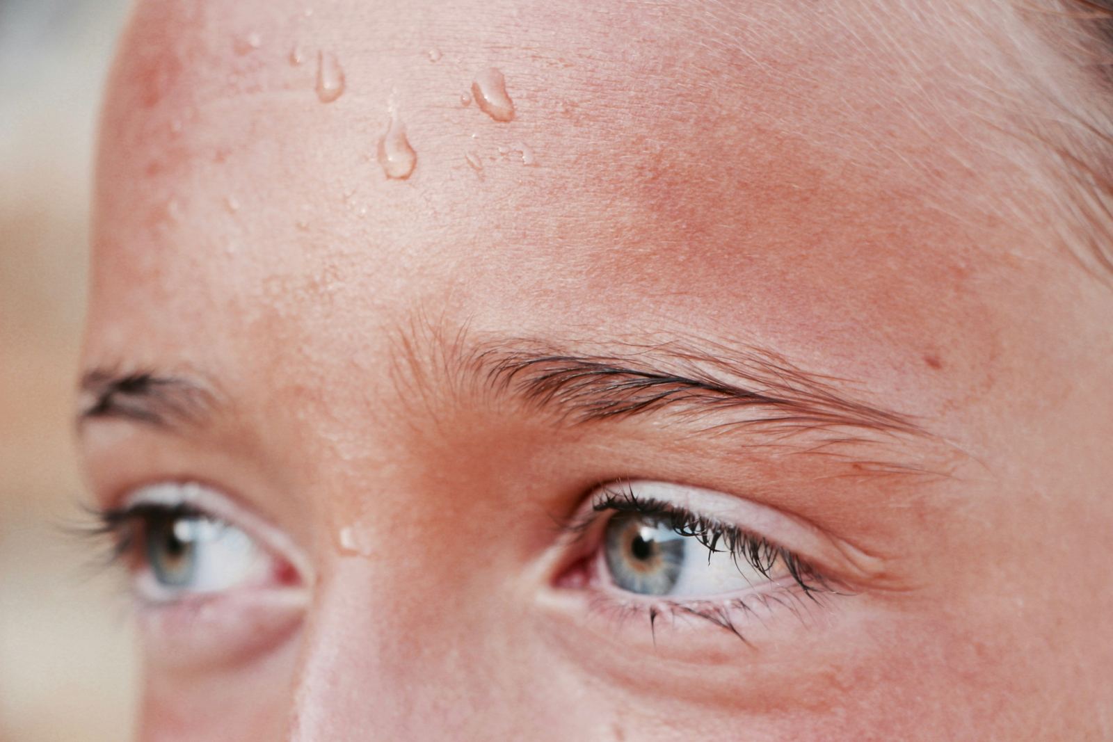 Close-up of beads of sweat on a person's forehead