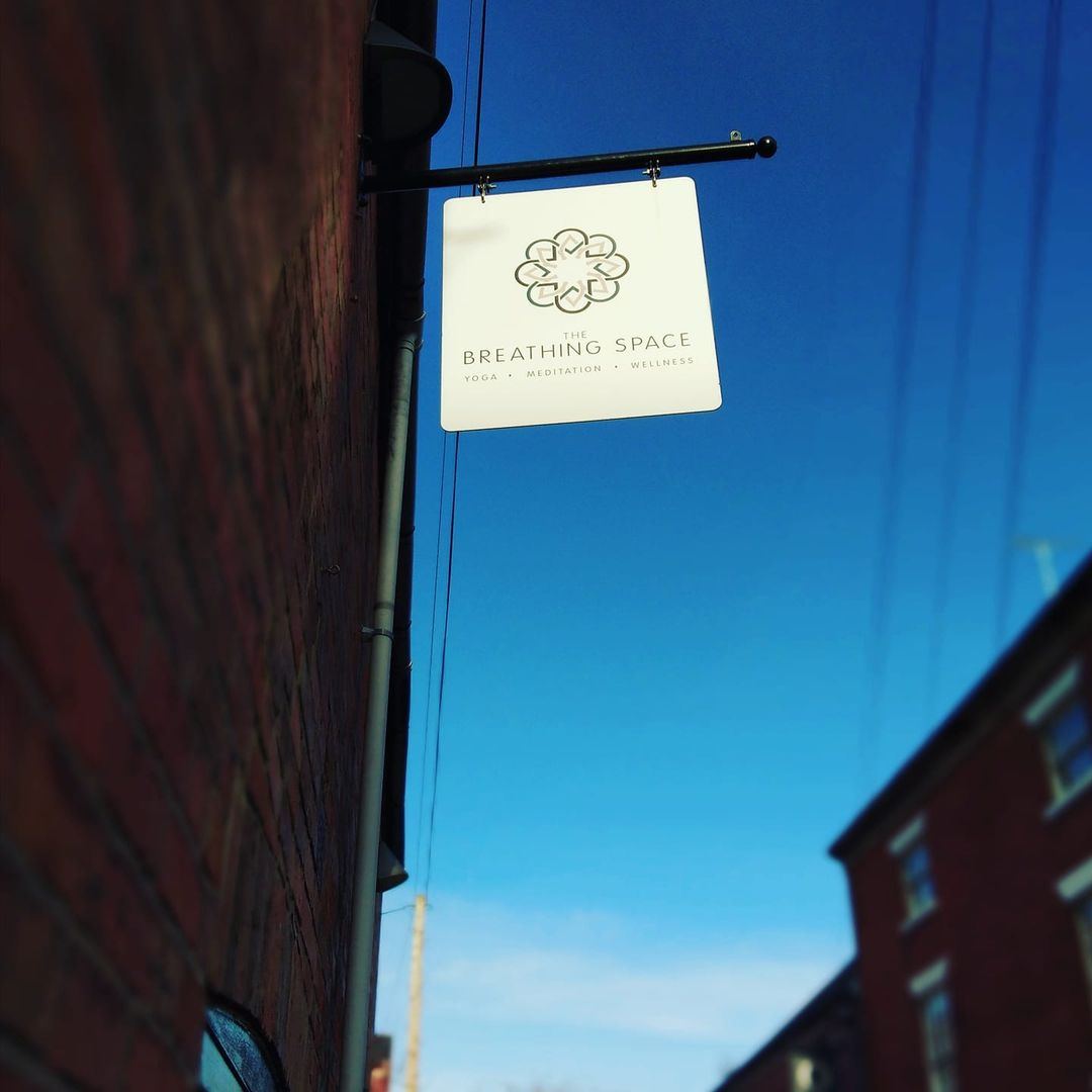 The studio's hanging sign against a blue sky